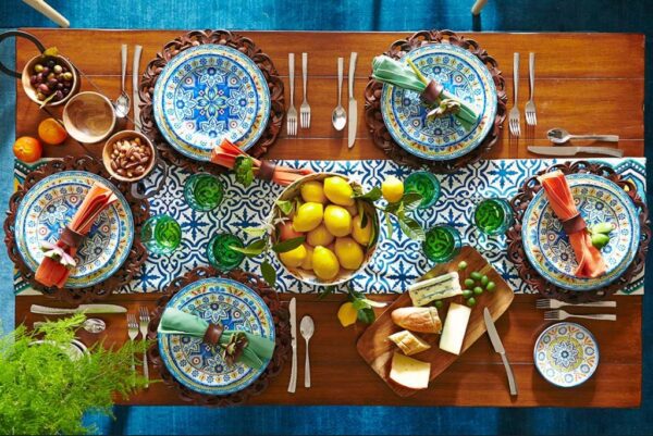 A table set with plates and bowls of food.