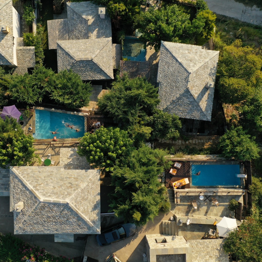 A bird 's eye view of some houses and pools.